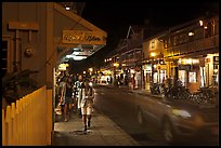 Tourists strolling store-lined street at night. Lahaina, Maui, Hawaii, USA