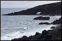 Dark coastline with sea tunnel. Maui, Hawaii, USA