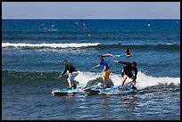 Surfing students ride the same wave. Lahaina, Maui, Hawaii, USA (color)