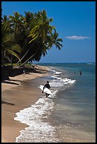 Surfer walking on beach. Lahaina, Maui, Hawaii, USA