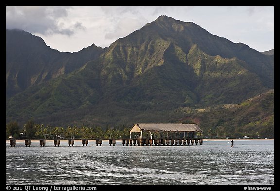 Hanalei Pier, mountains, and surfer. Kauai island, Hawaii, USA (color)