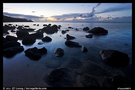 Boulders in water near Kalihika Park, sunset. Kauai island, Hawaii, USA