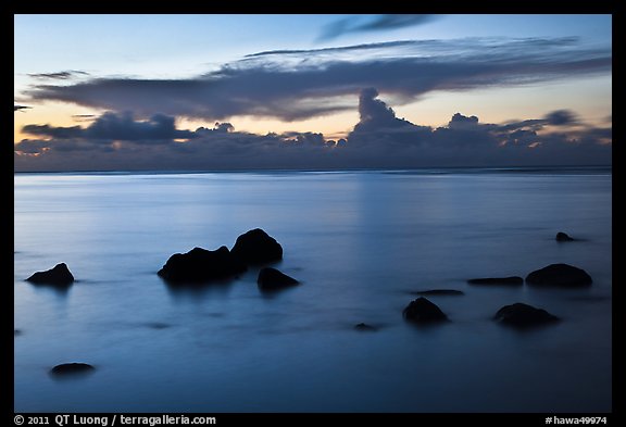 Rocks and cloud band, sunset. Kauai island, Hawaii, USA