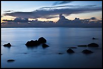 Rocks and cloud band, sunset. Kauai island, Hawaii, USA