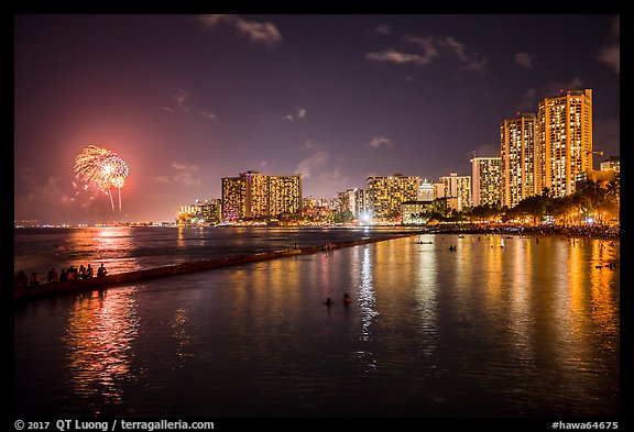 Watching fireworks from seawall, Kuhio Beach, Waikiki. Waikiki, Honolulu, Oahu island, Hawaii, USA (color)