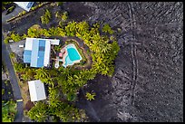 Aerial view of house and pool on edge of lava field. Big Island, Hawaii, USA ( color)