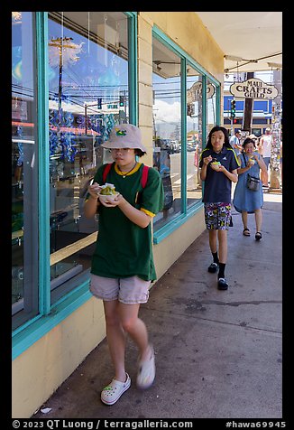 Family walking with Hawaiian Shave Ice, Paia. Maui, Hawaii, USA (color)