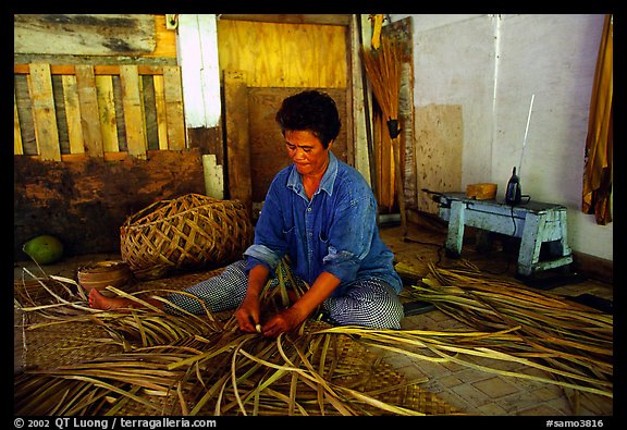 Woman weaving toga out of pandamus leaves, Tau Island. American Samoa (color)