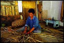 Woman weaving a toga (mat) out of pandamus leaves. American Samoa (color)