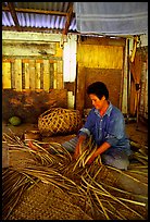 Woman weaving a toga (mat) out of pandamus leaves. American Samoa