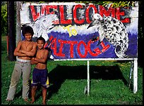 Children in front of a turtle a shark sign in Vaitogi. Tutuila, American Samoa ( color)