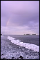 Rainbow at sunset, wave, and Aunuu island. Aunuu Island, American Samoa (color)