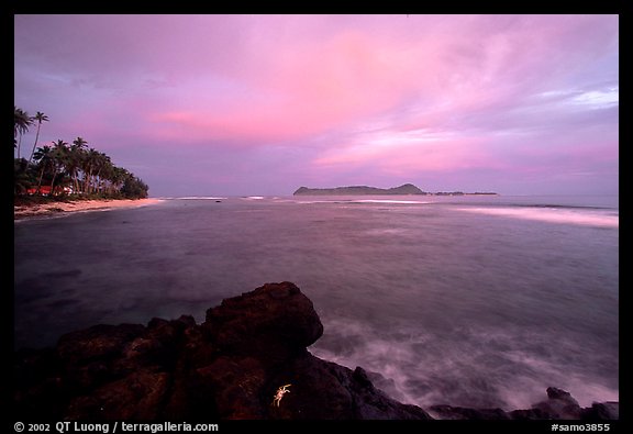 Sunset over Aunuu island with crab on basalt rock. Aunuu Island, American Samoa