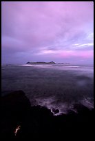 Sunset over Aunuu island with crab on basalt rock. Aunuu Island, American Samoa