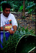 Villager weaving a basket out of a single palm leaf. Tutuila, American Samoa