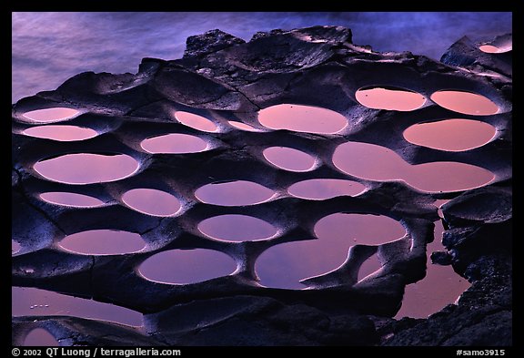 Water-filled ancient grinding stones (foaga) near Leone at sunset. Tutuila, American Samoa