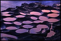 Water-filled ancient grinding stones (foaga) near Leone at sunset. Tutuila, American Samoa (color)