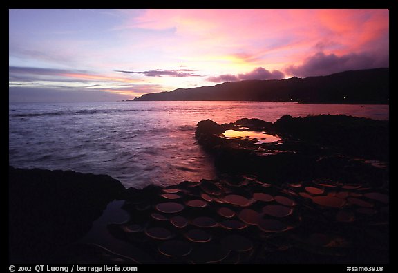 Ancient grinding stones (foaga) and Leone Bay at sunset. Tutuila, American Samoa (color)
