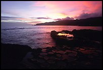 Ancient grinding stones (foaga) and Leone Bay at sunset. Tutuila, American Samoa