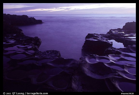 Ancient grinding stones (foaga) and Leone Bay at dusk. Tutuila, American Samoa (color)