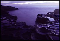 Ancient grinding stones (foaga) and Leone Bay at dusk. Tutuila, American Samoa