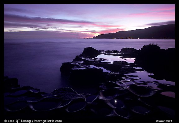 Grinding stones holes (foaga) filled with water at dusk, Leone Bay. Tutuila, American Samoa