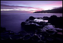 Grinding stones holes (foaga) filled with water at dusk, Leone Bay. Tutuila, American Samoa