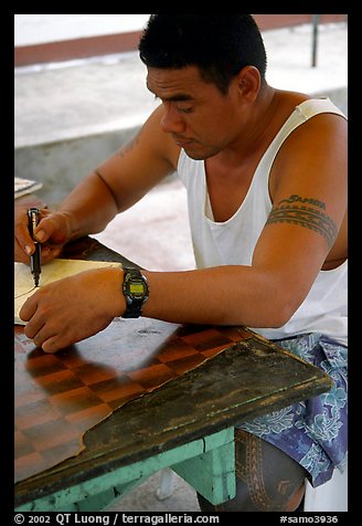 Young man drawing an artwork based on traditional siapo designs. Pago Pago, Tutuila, American Samoa
