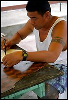 Young man drawing an artwork based on traditional siapo designs. Pago Pago, Tutuila, American Samoa