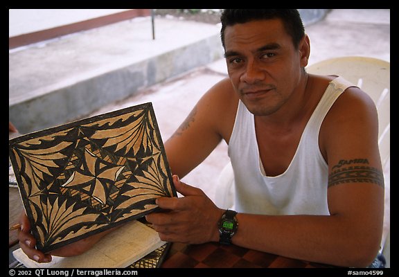 Young man showing an artwork based on traditional siapo designs. Pago Pago, Tutuila, American Samoa (color)