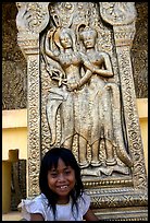 Girl and sculpture at Wat Phnom. Phnom Penh, Cambodia