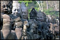 Statues near the gates of the temple complex. Angkor, Cambodia (color)