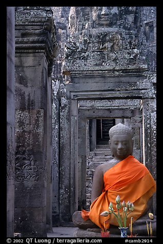 Buddha image, swathed in reverence, with offerings, the Bayon. Angkor, Cambodia
