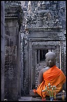 Buddha image, swathed in reverence, with offerings, the Bayon. Angkor, Cambodia