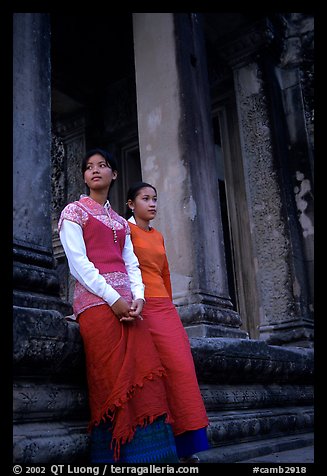 Elegant young women near temple entrance. Angkor, Cambodia