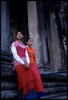 Elegant young women near temple entrance. Angkor, Cambodia (color)