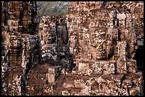 Large stone smiling faces on upper terrace, the Bayon. Angkor, Cambodia