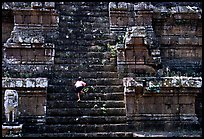 Boy climbs near-vertical staircase, Angkor Thom complex. Angkor, Cambodia ( color)