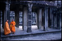 Two Buddhist monks in dark temple, Angkor Wat. Angkor, Cambodia ( color)