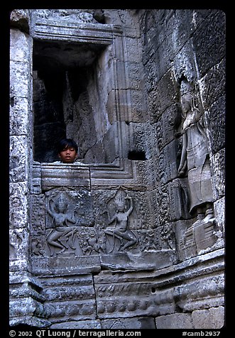 Boy hides in the Bayon. Angkor, Cambodia (color)