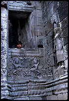 Boy hides in the Bayon. Angkor, Cambodia ( color)