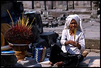 Incence vendor wearing traditional headcloth. Angkor, Cambodia ( color)