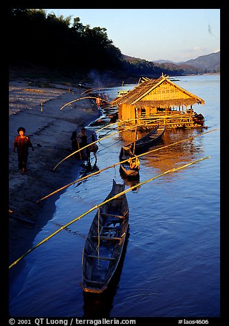 Boats and stilt house of a small hamlet. Mekong river, Laos