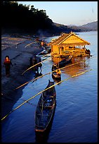 Boats and stilt house of a small hamlet. Mekong river, Laos