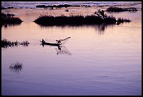 Fisherman casts net at sunset in Huay Xai. Laos (color)