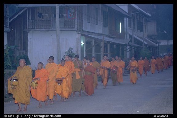 Morning alms procession of buddhist monks. Luang Prabang, Laos (color)