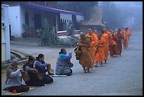 Women line up to offer alm to buddhist monks. Luang Prabang, Laos ( color)