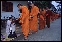 Buddhist monks receiving alm from woman. Luang Prabang, Laos ( color)