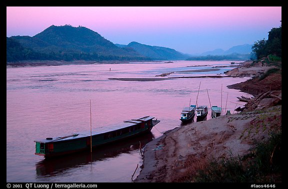 Dusk on the Mekong river framed by coconut trees. Luang Prabang, Laos (color)