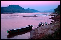 Dusk on the Mekong river framed by coconut trees. Luang Prabang, Laos